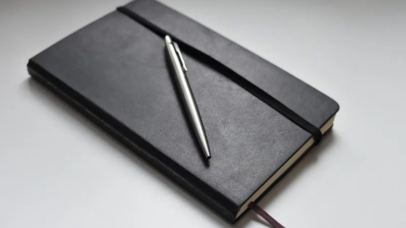 Moleskine Classic Hardcover Large notebook in black with elastic closure and ribbon bookmark, showing the back pocket — blank journal trusted by writers and thinkers worldwide
