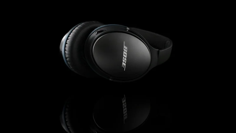 Over-ear headphones resting on a light-wood desk beside a coffee mug, calm home office morning