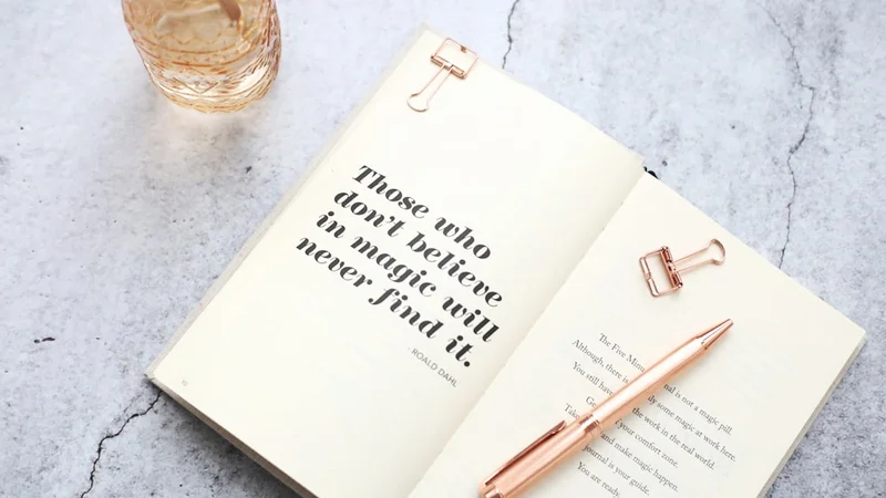 An open journal on a wooden desk with handwritten notes, morning coffee cup, soft daylight