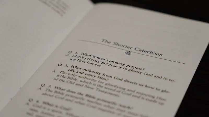 An open leather-bound decision journal on a wooden desk, showing handwritten dated entries and short notes, a black pen resting across the page, soft morning light from a nearby window