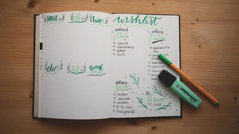 Close-up of an open notebook filled with handwritten brain dump entries, a pen resting across the page, morning light from a window