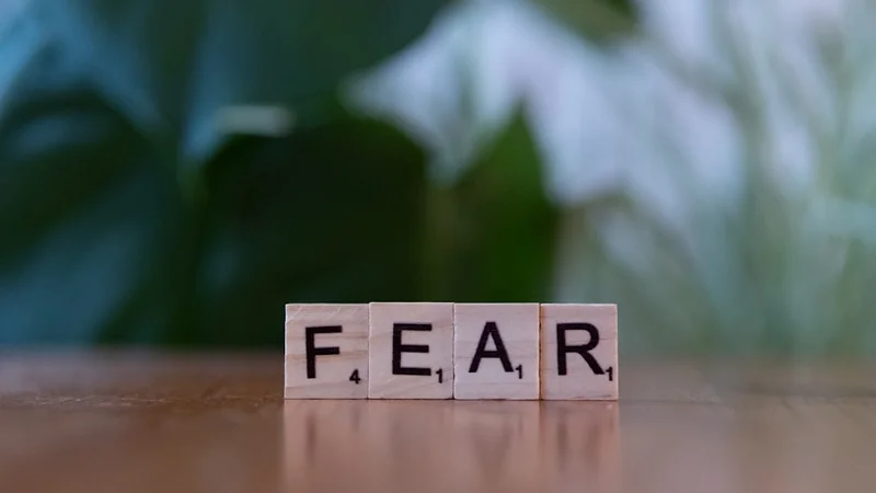 A notebook open to three pages showing the fear-setting framework with handwritten notes, columns for Define, Prevent, Repair, and Cost of Inaction