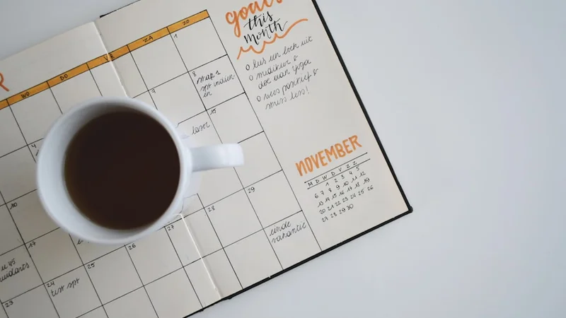 person writing an if-then plan in a minimalist journal at a morning-lit wooden desk