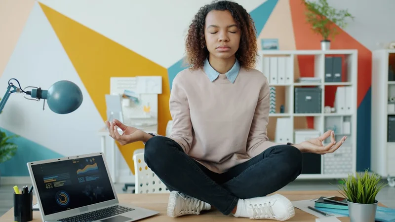 A minimal, sunlit desk with a single open notebook, a pen, and a coffee cup — no clutter anywhere