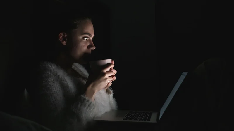 person lying awake in the dark staring at the ceiling, soft ambient light, cinematic and quiet