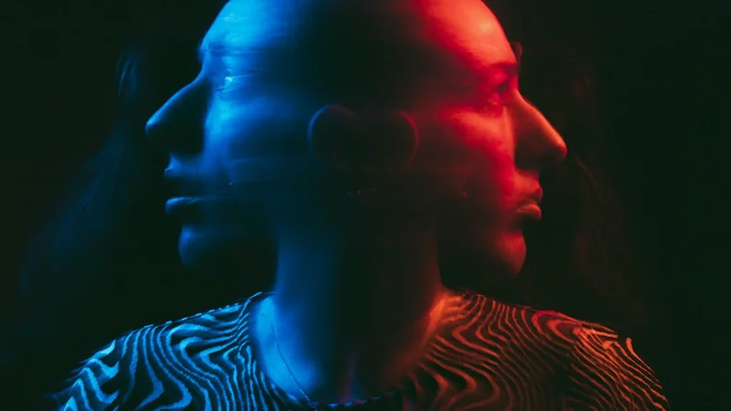 A mother and infant in warm face-to-face interaction, matching expressions, soft natural light — representing emotional attunement and reciprocal engagement in the Still Face Paradigm