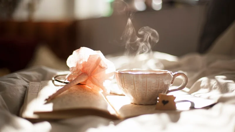 minimalist morning desk with a single journal and cup of tea beside a window with soft natural light — no screens, no devices