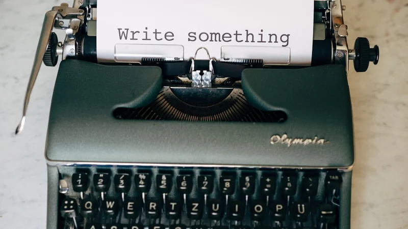 close-up of hands holding an open notebook, pen resting across the page, warm light — journaling after rejection